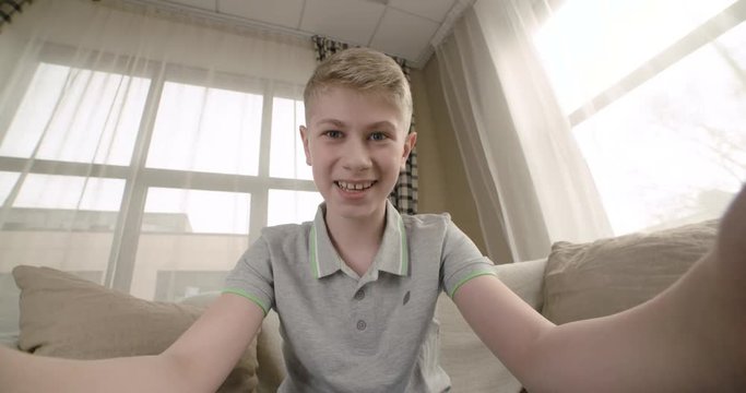 Happy funny teenager having a video chat. Point of view of the computer screen. 4K