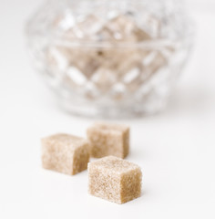 Cane sugar cubes on a white background