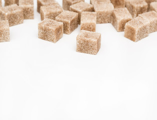 Cane sugar cubes on a white background