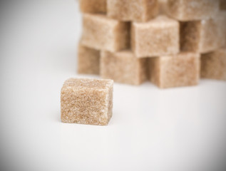 Cane sugar cubes on a white background