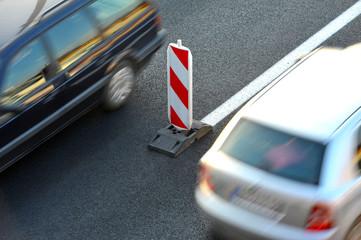 Moving Cars passing road sign