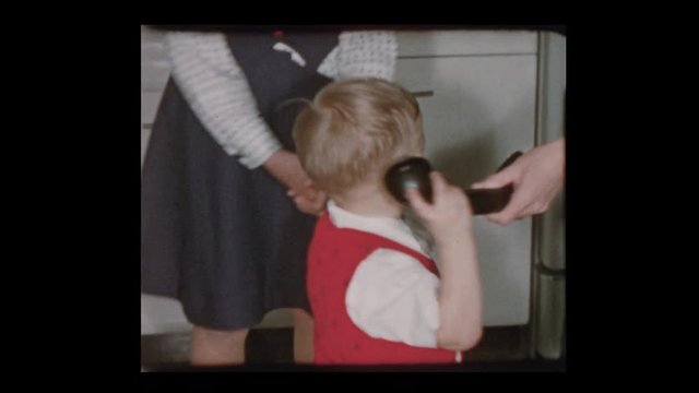 1954 Cute little boy on old fashioned telephone