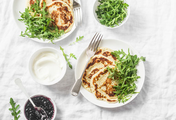 Gluten free chickpea pancake and arugula. Healthy diet breakfast or snack on white background, top view