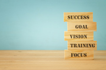 Stack of wooden Bricks With Motivational Words. success concept