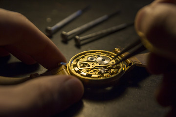 Clockmaker is repairing wrist watch. Close up