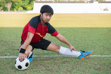 Portrait of asian soccer player warm up before big match in the field,Thailand people