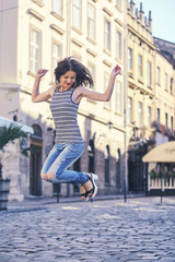 Fototapeta na wymiar handsome woman jumping in the street