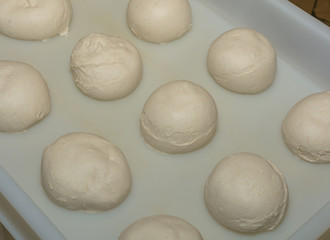 balls of fresh pasta for pizza. Food, italian cuisine and cooking concept. Preparation of the Italian Pizza