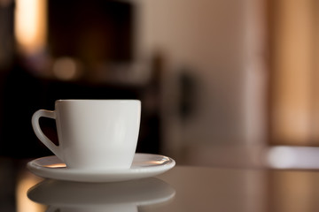 Coffee in a white cup on the table.