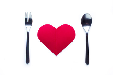 Valentine's day concept fork and spoon indicating a dinner seen from above.