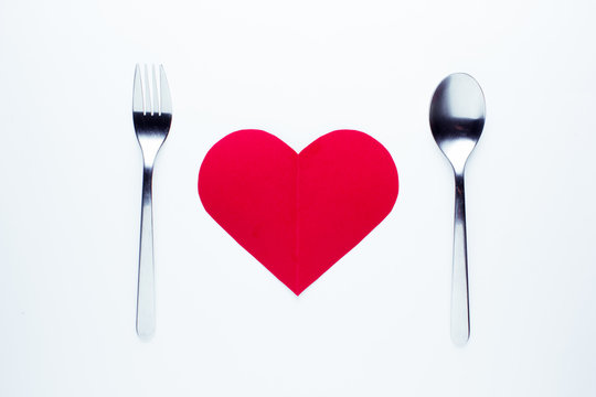 Valentine's day concept fork and spoon indicating a dinner seen from above.