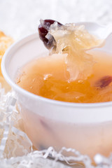 Tremella soup. Closeup of tremella and chinese dates in a spoon.