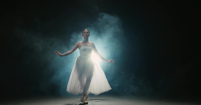 4K video footage beautiful Asian girl ballet dancer dancing on black background slow motion