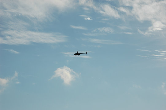 hellicopter fly alone blue sky oarty cloud