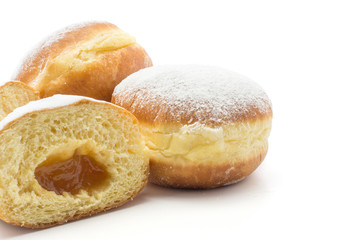 Obraz na płótnie Canvas Doughnuts (Sufganiyah) with apricot jam isolated on white background fresh baked with powered sugar.