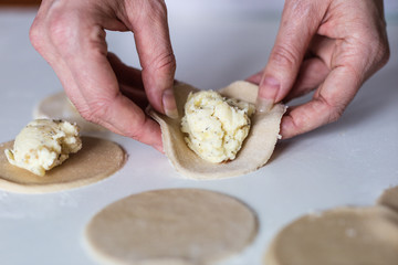 Tasty dumplings with potato filling. Making dumplings in the kitchen.