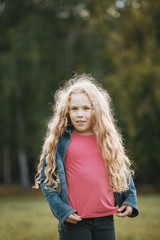 Pretty smiling child girl walking in park