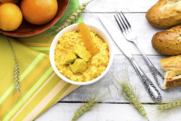 homemade arabic food basmati rice with chicken and carrot in white glass bowl, baguette bread and orange fruit 