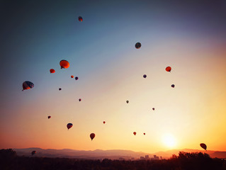 hot air balloon in the sky during sunrise toned with a retro vintage instagram filter app or action effect