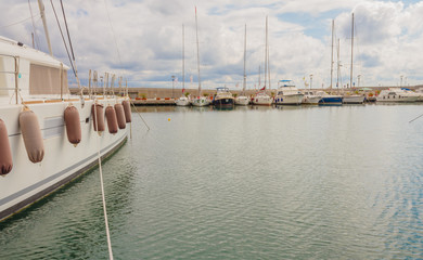 Fototapeta premium the boats anchored at the harbor / detail of a boat anchored with the typical fenders