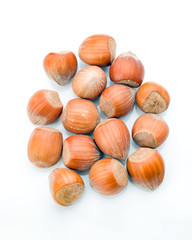 hazelnuts with shell on white background