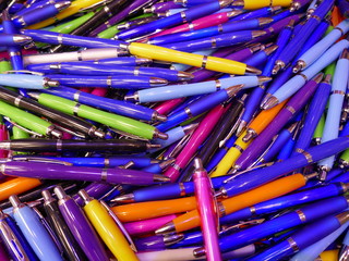 Many colorful, glossy ballpoint pens