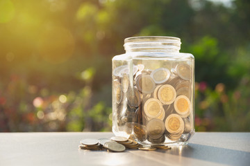 Coins in jar with money stack, Concept finance, accounting, business and saving investment.