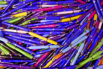 Many colorful, glossy ballpoint pens