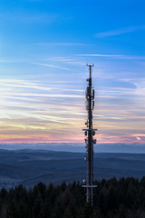 Obraz premium At the highest point in the mountains stands a telecommunication tower. A very good transmission power guaranteed. Concept: communication and landscape