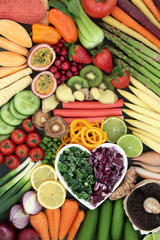Super food for a healthy diet concept with fresh vegetables and fruit with foods high in anthocyanins, antioxidants, dietary fiber, vitamins and minerals. Top view background.