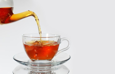 Pouring tea to a teacup