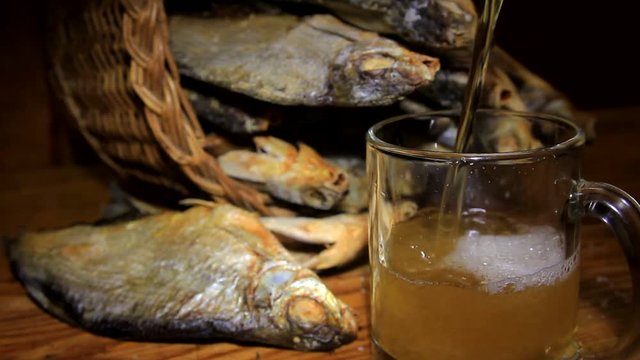 dry fish in a basket and beer