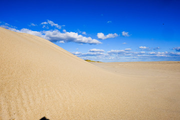 Fototapeta na wymiar Sun Sand Clouds Blue Sky