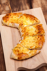 khachapuri (ghvezeli) in a half moon form for christmas day, Georgia