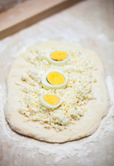 dough with cheese and egg for cooking traditional Georgian dish khachapuri  in a half moon form for christmas day, ghvezeli