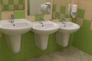 Sinks in a public toilet for the different growth