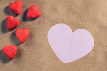 Red hearts on a brown paper background. Valentine's day