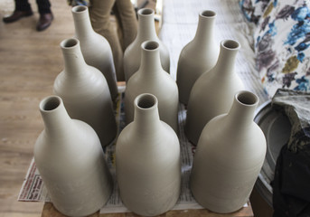 Fototapeta na wymiar Batch of traditional handmade bottle design from gray colour raw ceramic material after cooked