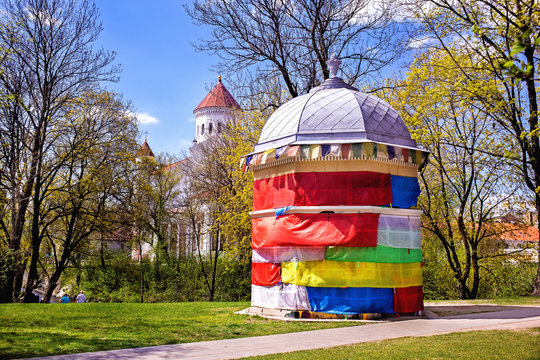 Colorfully decorated building at the Art Incubator in Užupis, Vilnius. Lthuania.The towers of the Orthodox Cathedral are seen behind it