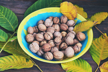 walnuts in a plate on a wooden table