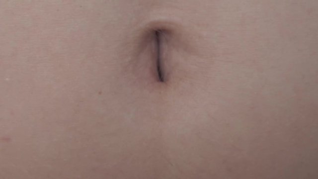 Female Navel Moving at Laughing. Extreme Close Up