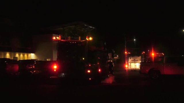 fire trucks driving to fire live action at night in street 4k