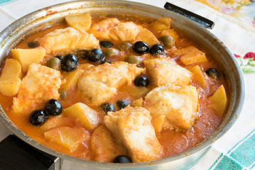 Salted cod stewed with olives