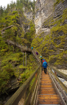 Woody bridge with walking tourists, Kitzlochklamm gorge, Austria
