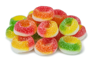 The colored fruit sweets on white background