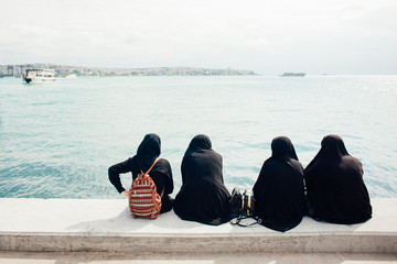 Women in a burqa near the sea