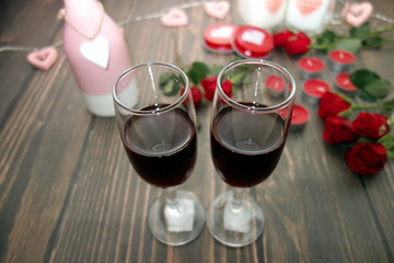 Wine glasses on flowers and hearts decoration background, Valentine`s Day concept