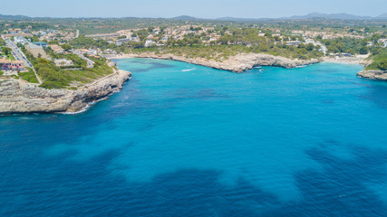 Drone aerial landscape of the beautiful bay of Cala Mandia and Anguila with a wonderful turquoise sea, Porto Cristo, Majorca, Spain
