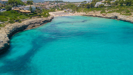 Drone aerial landscape of the beautiful bay of Cala Mandia with a wonderful turquoise sea, Porto Cristo, Majorca, Spain