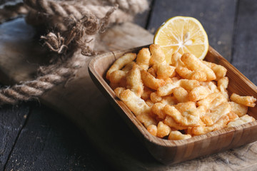 Tasty cheese fries on wooden table